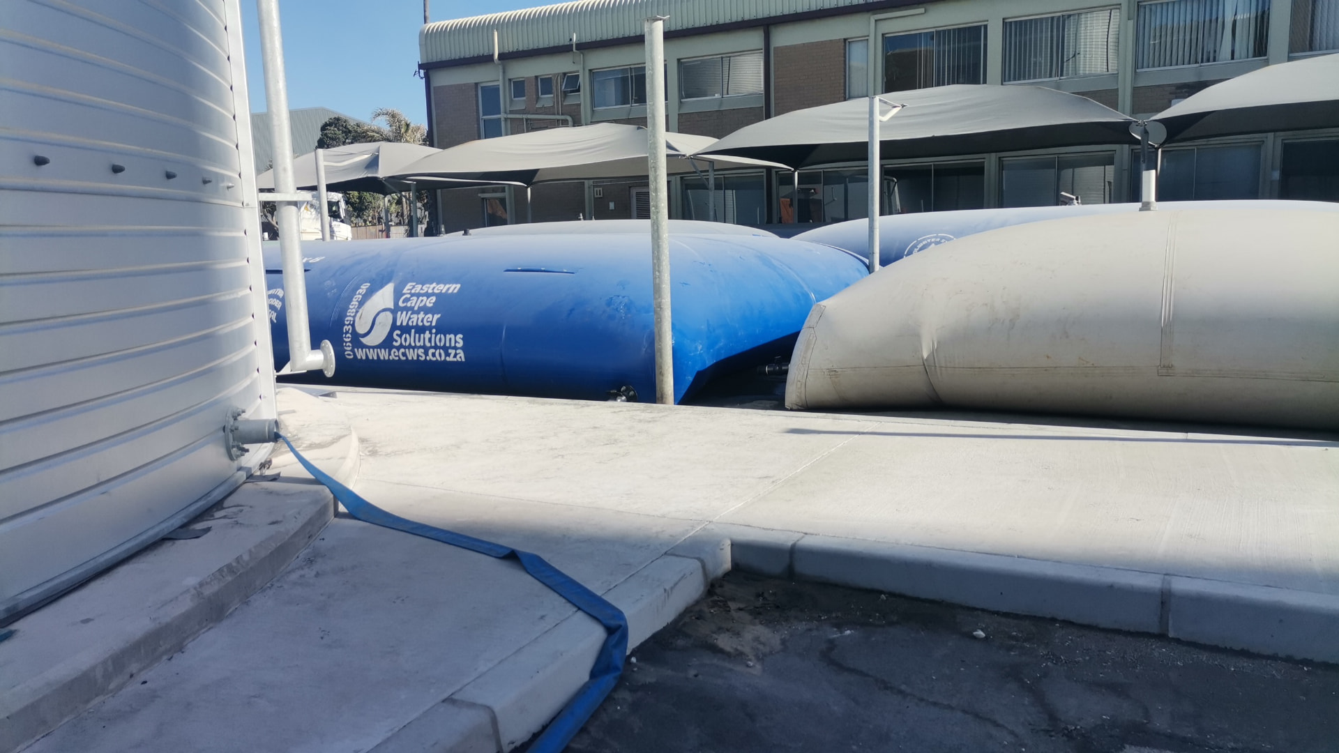 Multiple temporary water bladders linked together on a commercial property