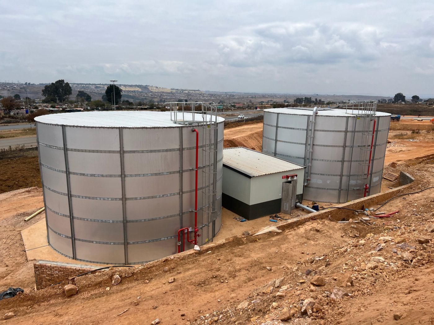 Aerial view of twin cylindrical steel fire water tanks and pump house at Leratong City Mall