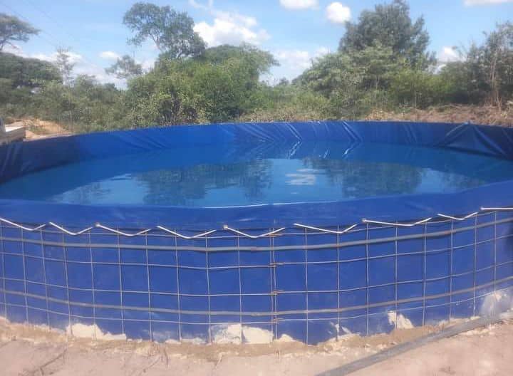 PVC dam liner installation with mesh support structure